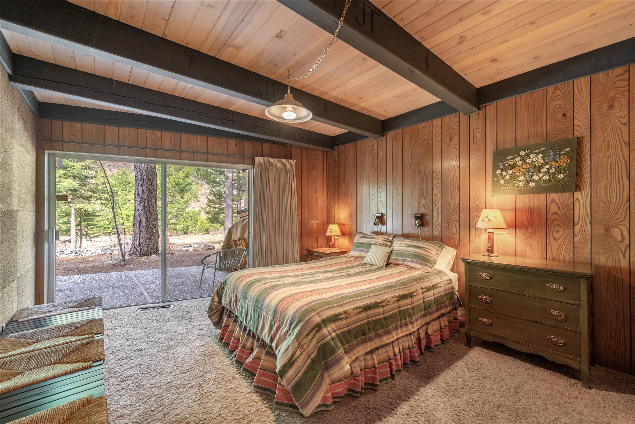 6860 River Road Truckee, CA 96161 - Photo 16 of 21 a bedroom with a bed dresser and a window