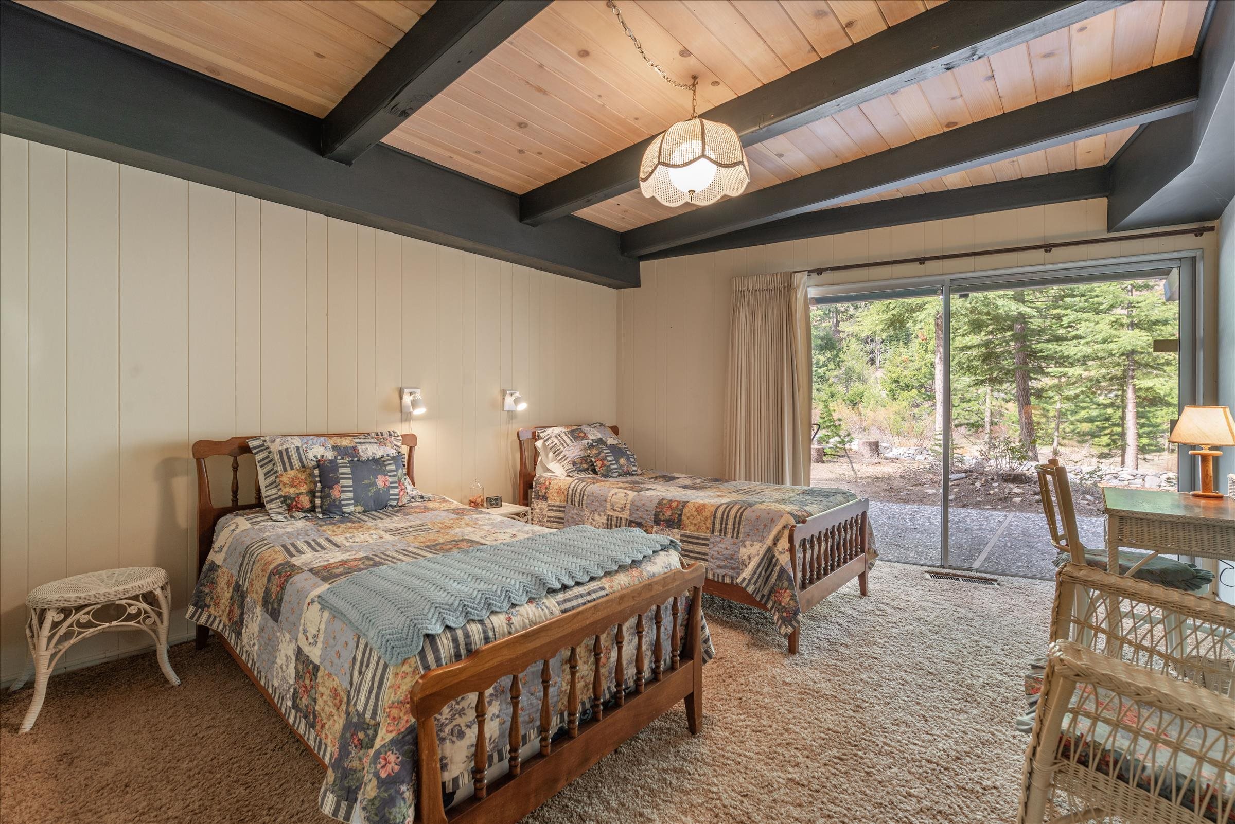 6860 River Road Truckee, CA 96161 - Photo 17 of 21 a bedroom with two beds and a large window