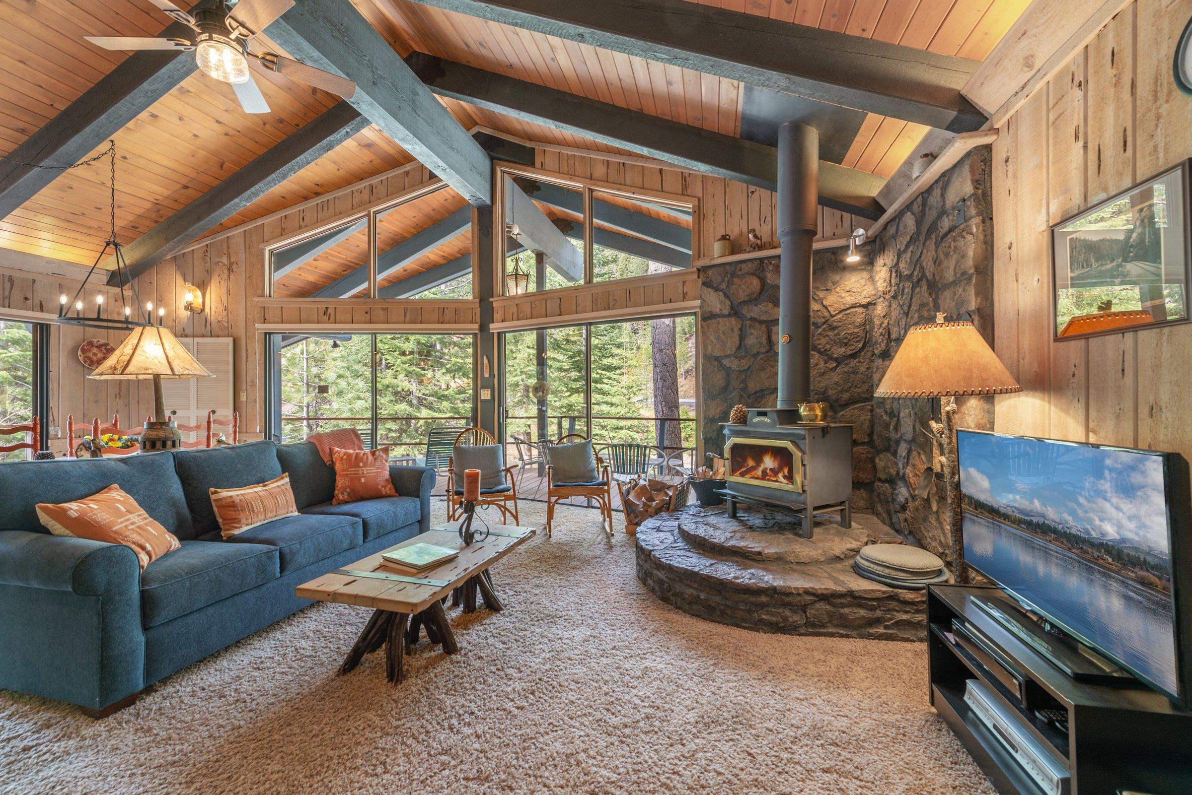 6860 River Road Truckee, CA 96161 - Photo 5 of 21 a living room with furniture a wooden floor and a large window