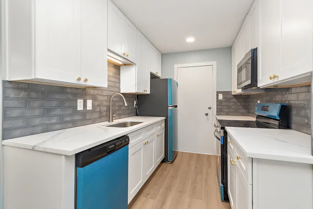 a kitchen with a sink stove and refrigerator