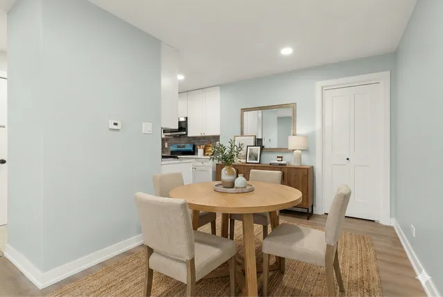 a view of a dining room with furniture and wooden floor