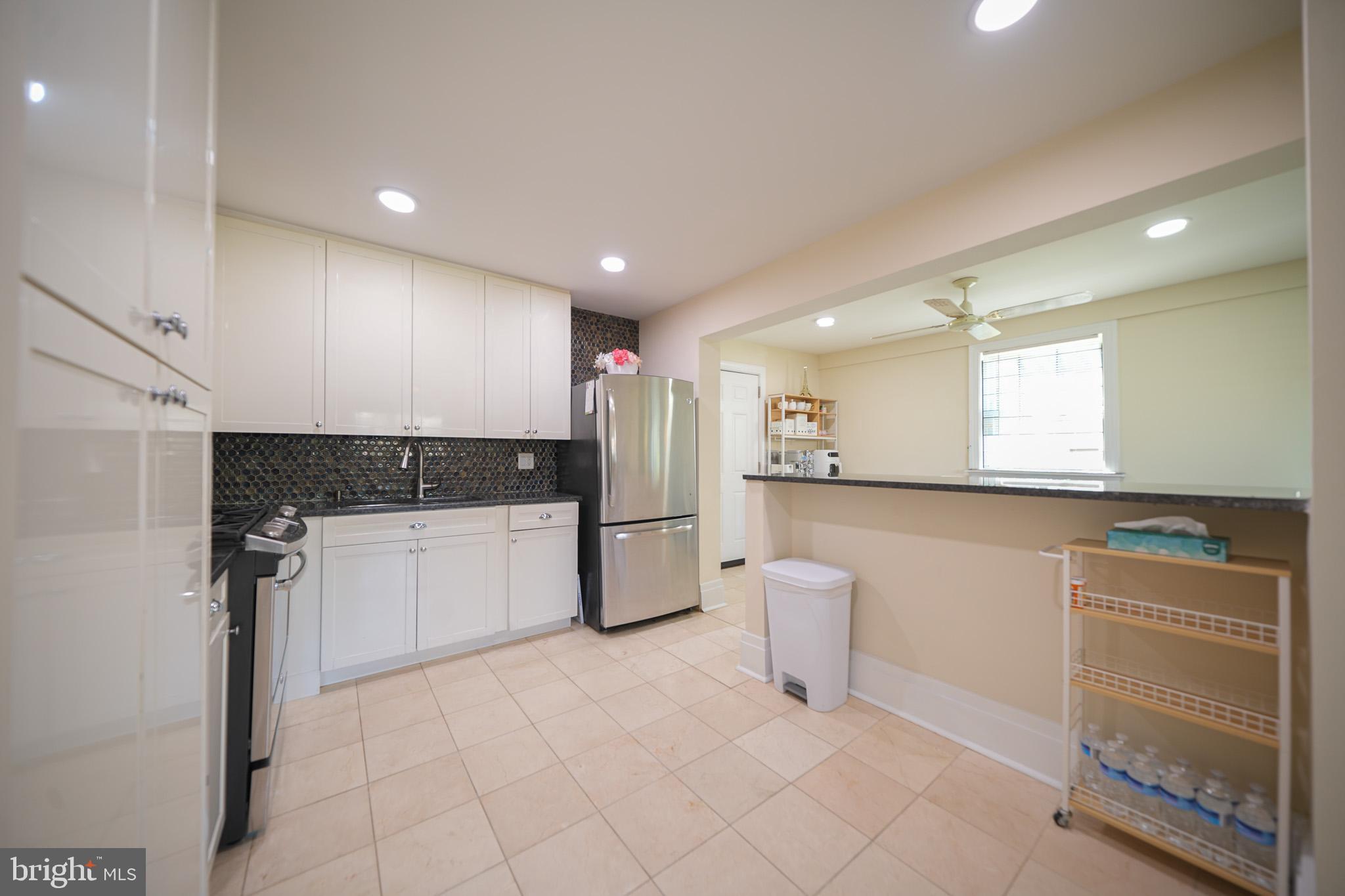 2001 Denison Street Baltimore, MD 21216 - Photo 11 of 43 a kitchen with a refrigerator and white cabinets