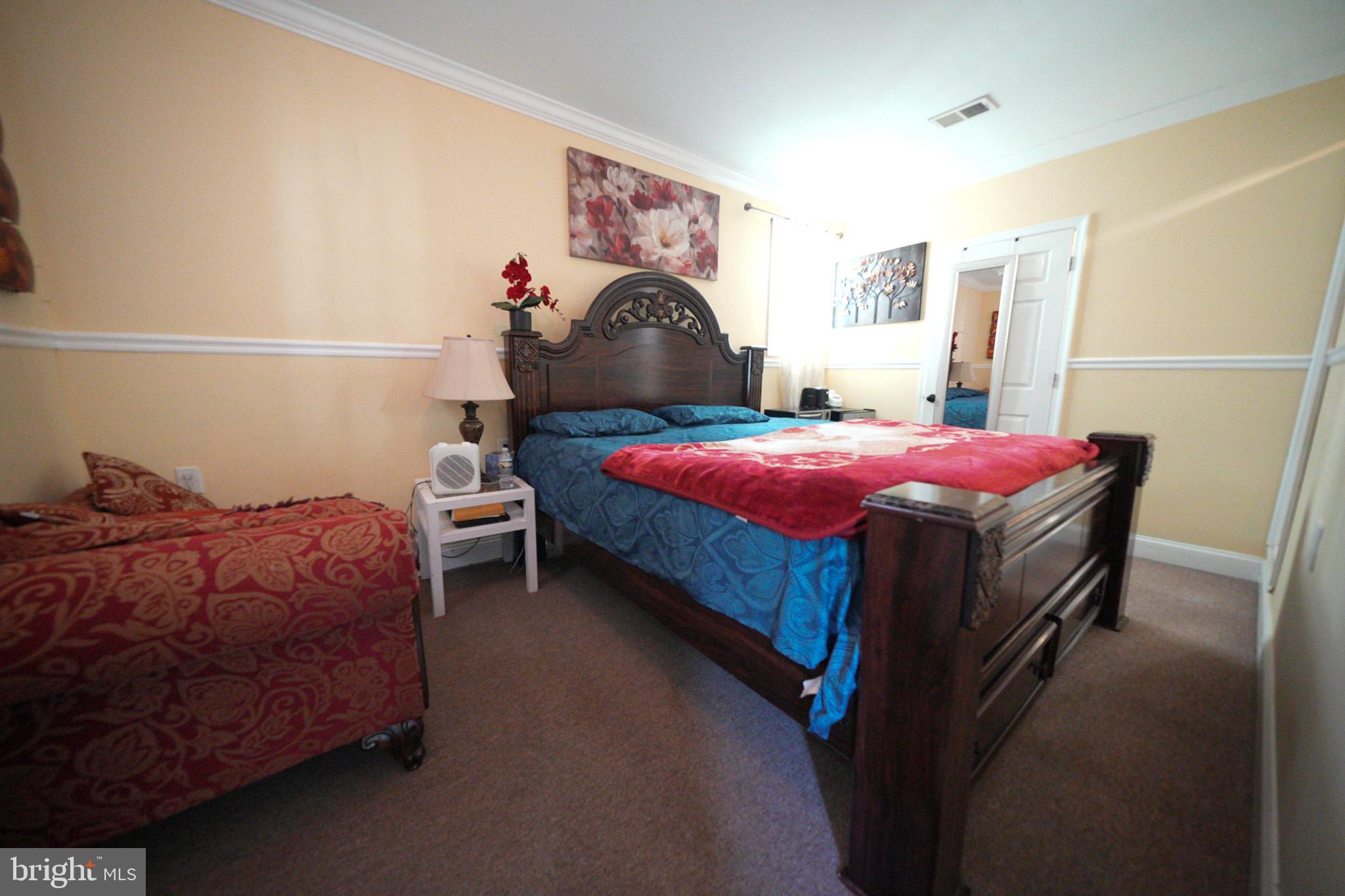 2001 Denison Street Baltimore, MD 21216 - Photo 14 of 42 a bedroom with a bed and a window