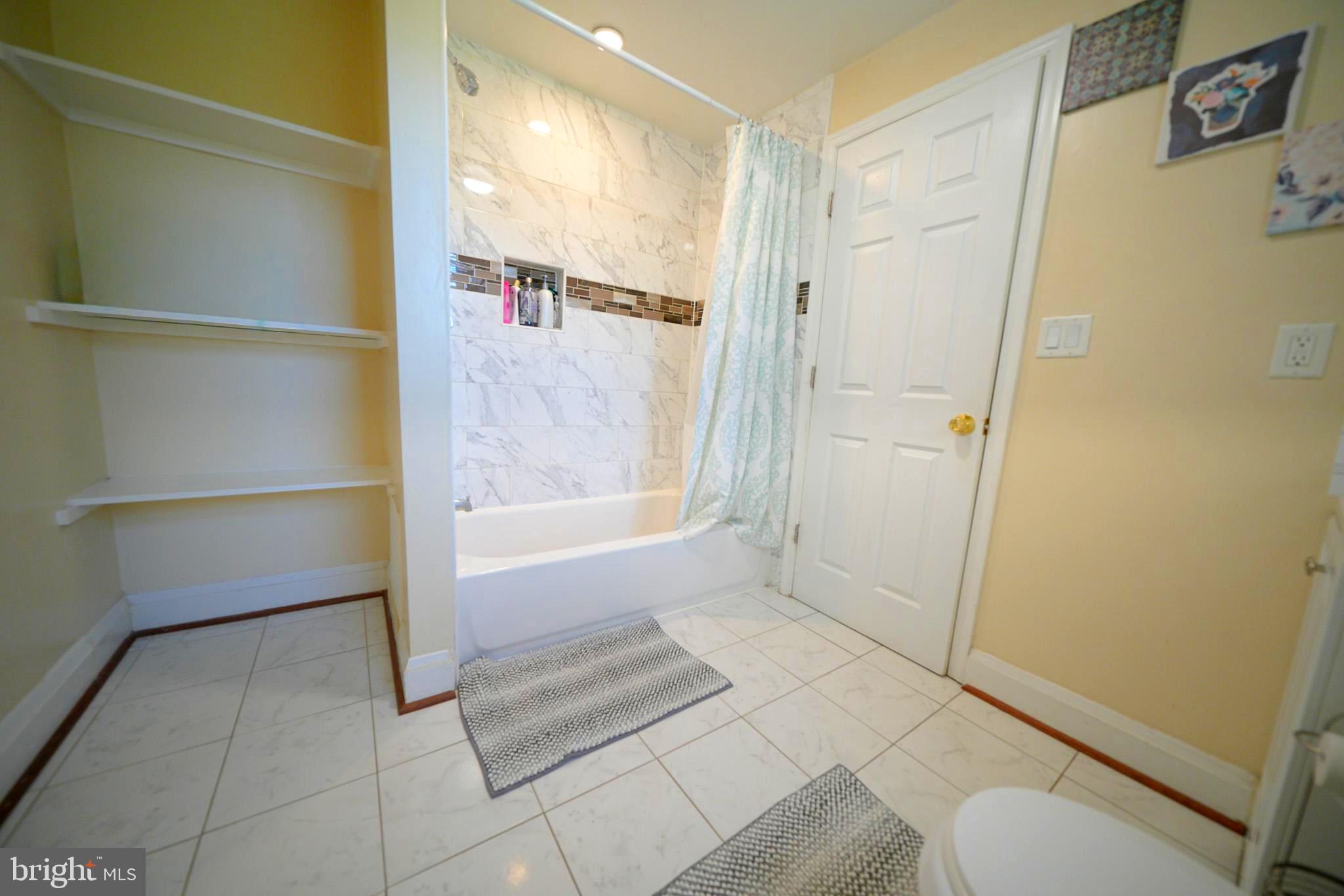2001 Denison Street Baltimore, MD 21216 - Photo 18 of 43 a bathroom with a tub and shower
