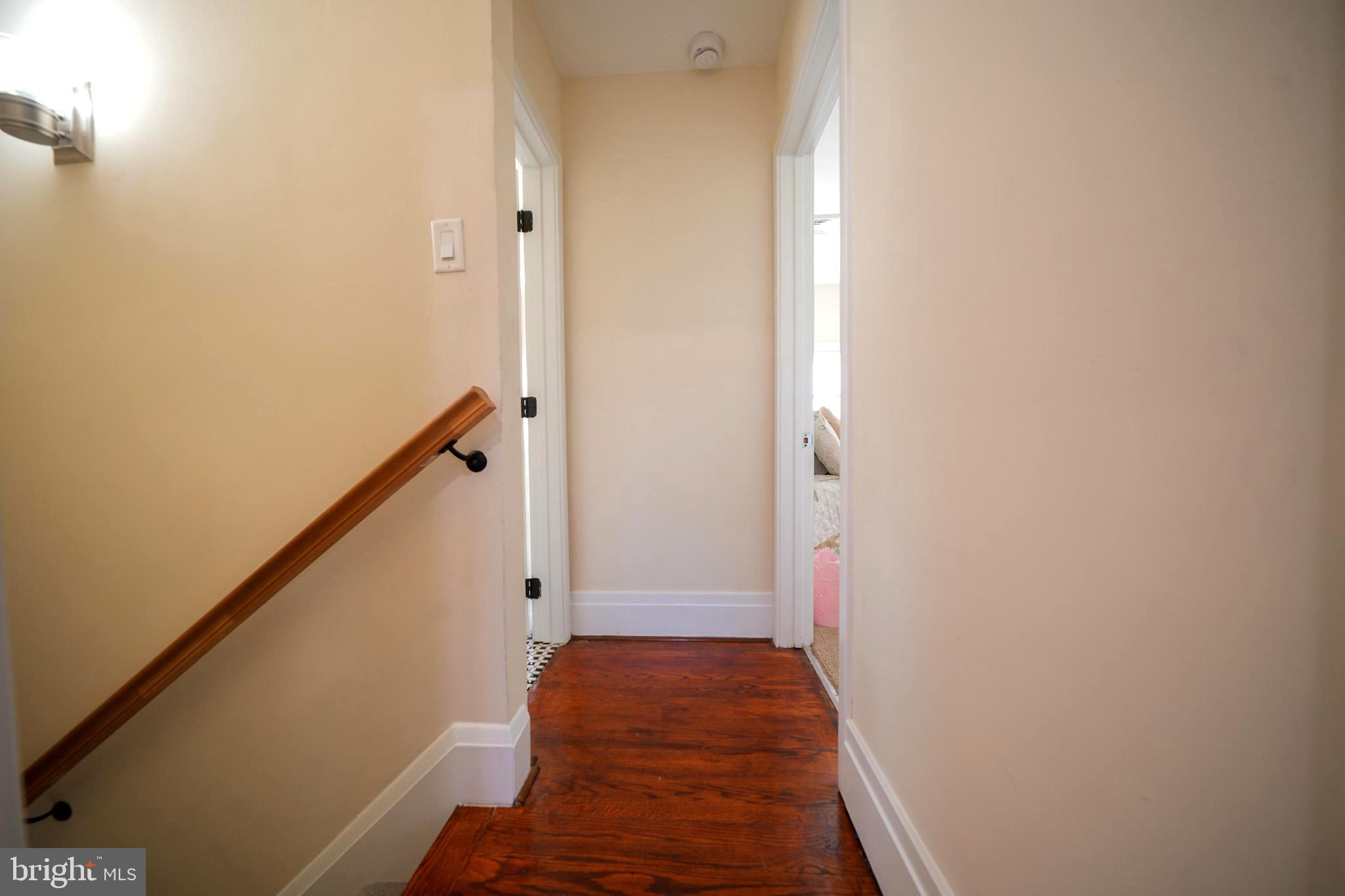 2001 Denison Street Baltimore, MD 21216 - Photo 22 of 43 a view of a hallway with wooden floor and staircase