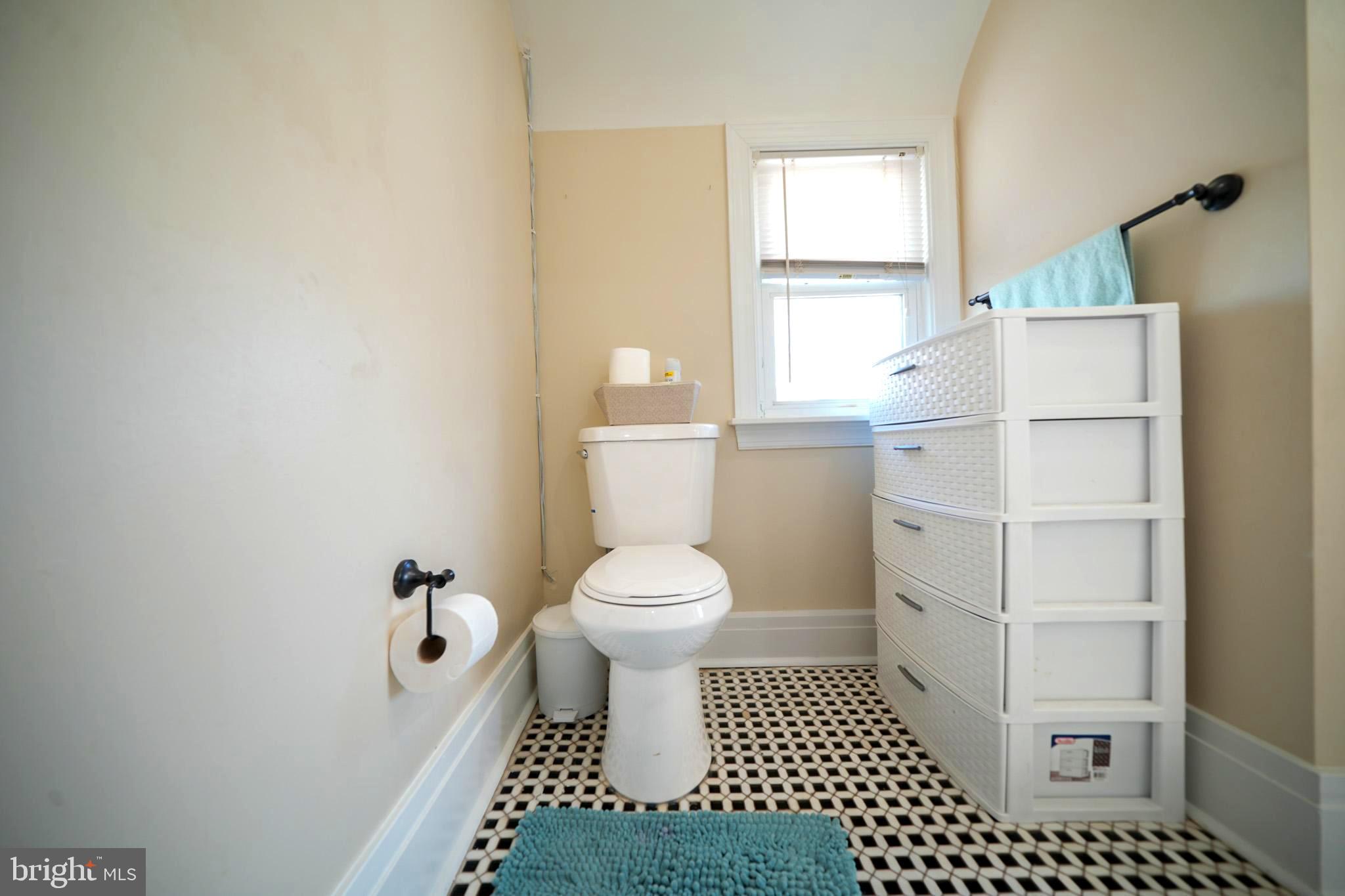 2001 Denison Street Baltimore, MD 21216 - Photo 23 of 43 a bathroom with a toilet a window and a shower