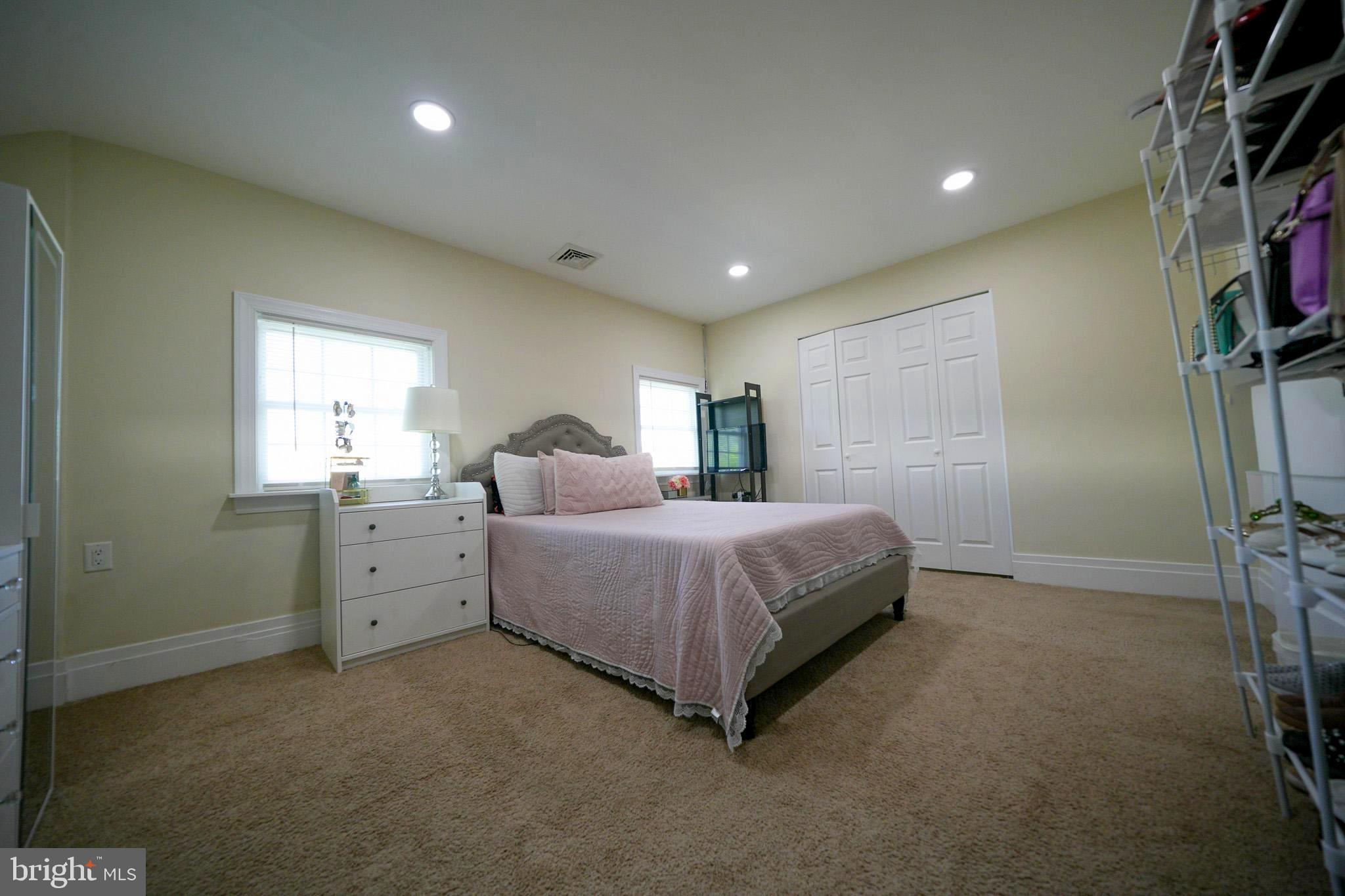 2001 Denison Street Baltimore, MD 21216 - Photo 31 of 43 a spacious bedroom with a bed and a flat screen tv