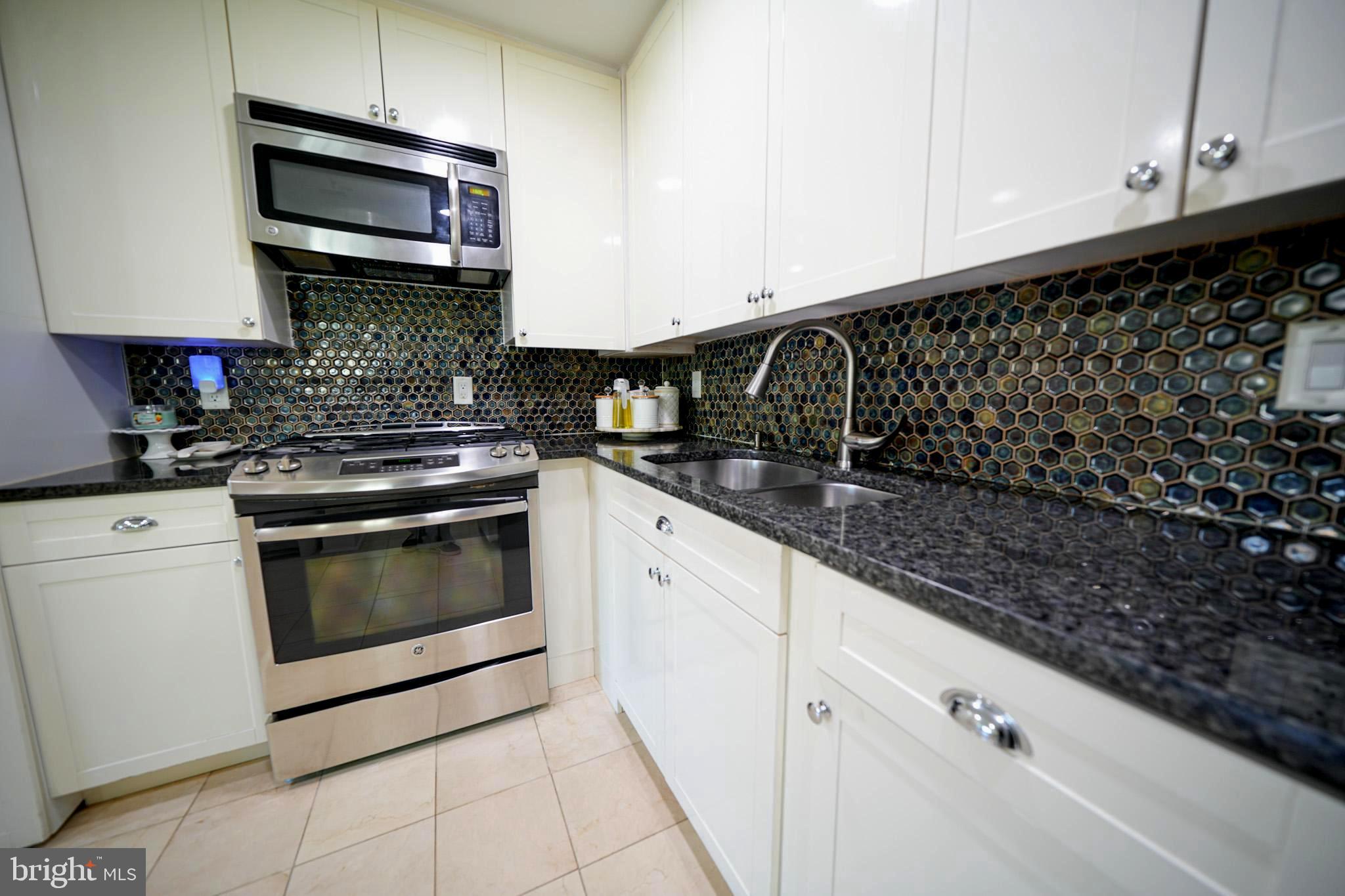 2001 Denison Street Baltimore, MD 21216 - Photo 9 of 43 a kitchen with granite countertop a stove and a sink