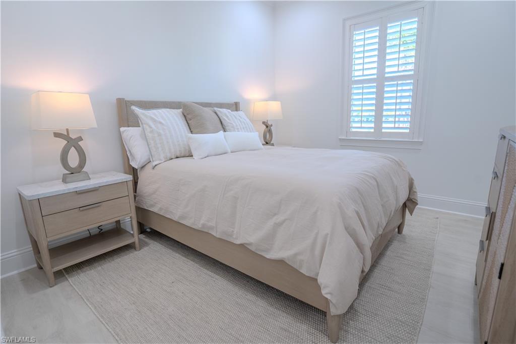 7150 Saona Court Naples, FL 34113 - Photo 9 of 31 a large bed sitting in a bedroom next to a window