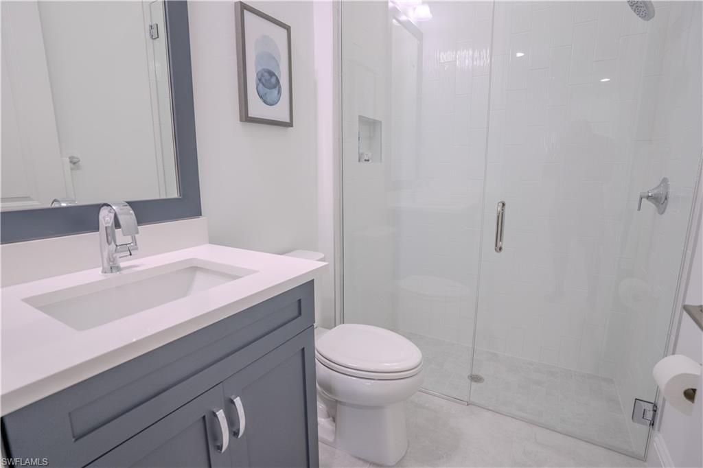 7150 Saona Court Naples, FL 34113 - Photo 11 of 31 a bathroom with a sink a toilet and shower