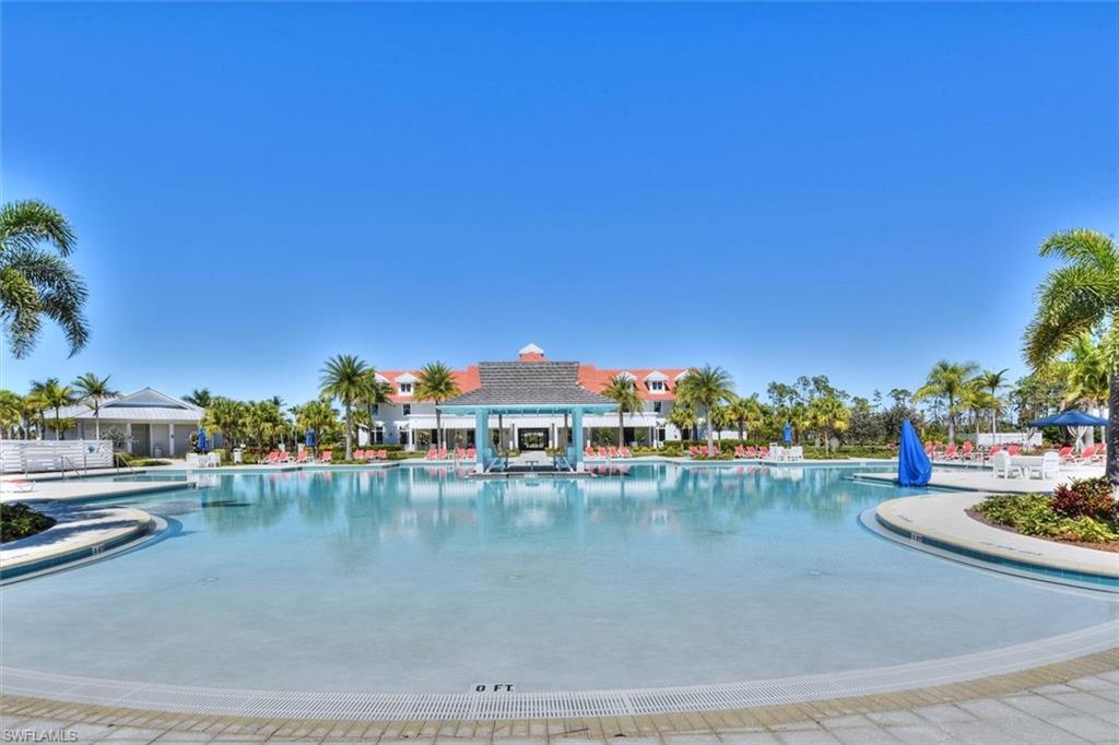 7150 Saona Court Naples, FL 34113 - Photo 23 of 31 a view of a swimming pool with a table and chairs