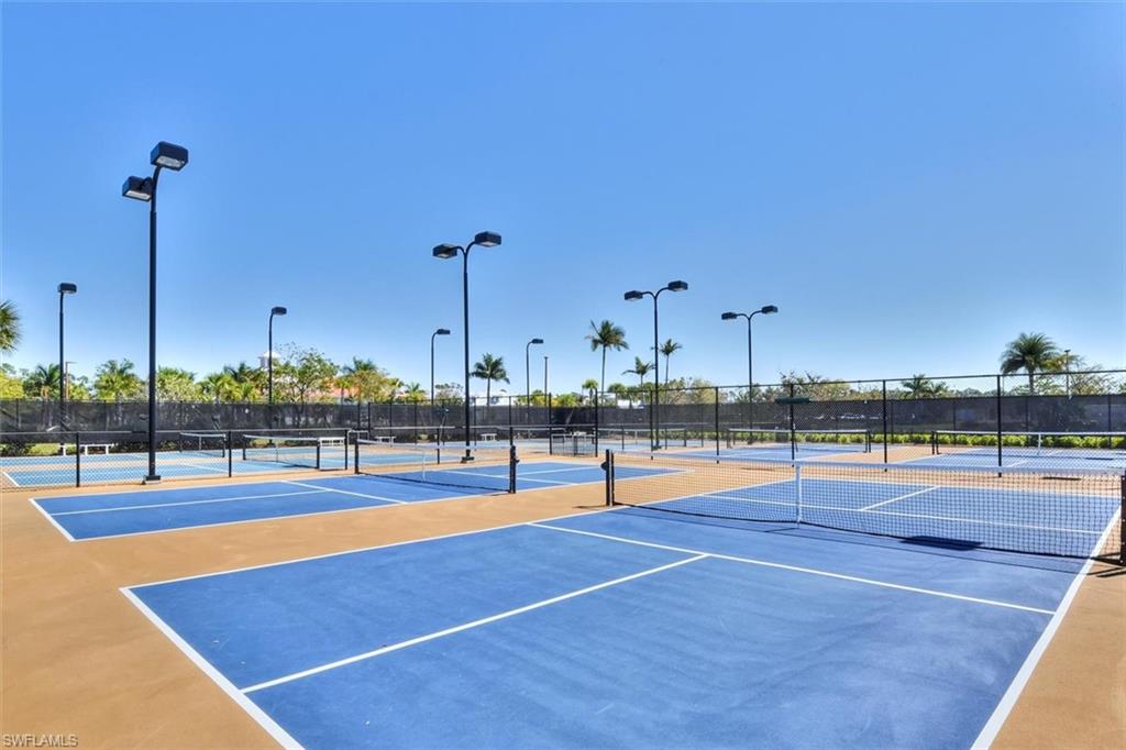 7150 Saona Court Naples, FL 34113 - Photo 27 of 31 a view of a swimming pool with a lawn chairs
