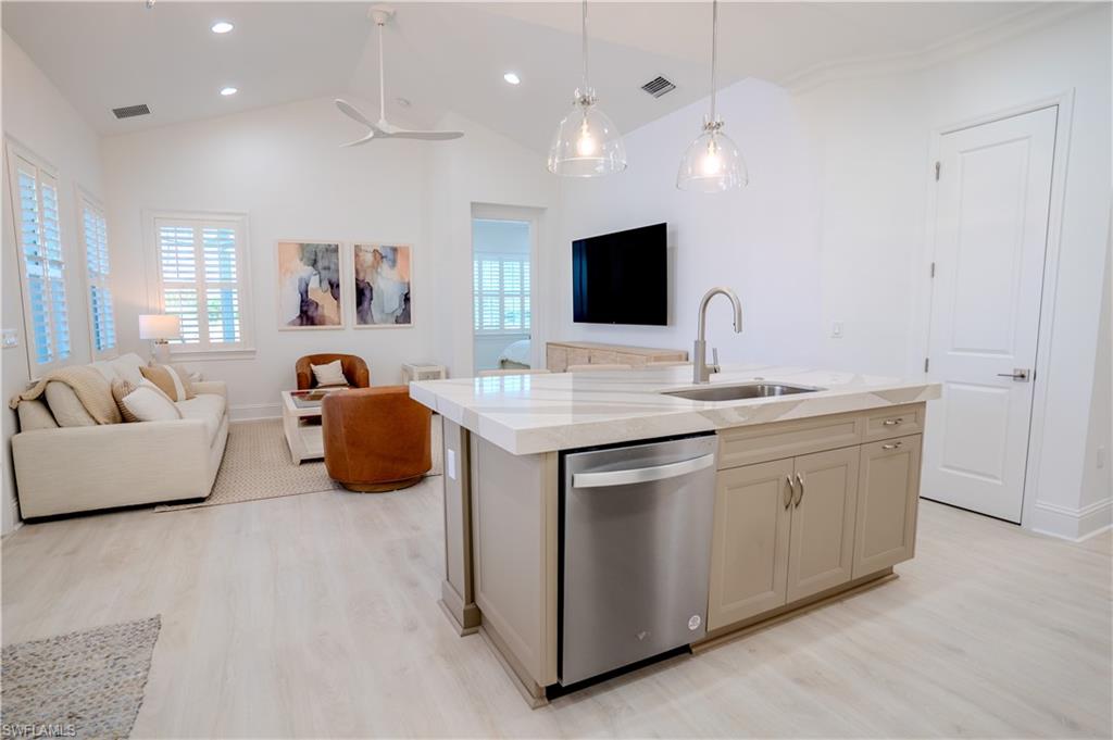 7150 Saona Court Naples, FL 34113 - Photo 31 of 31 a living room with furniture and a flat screen tv