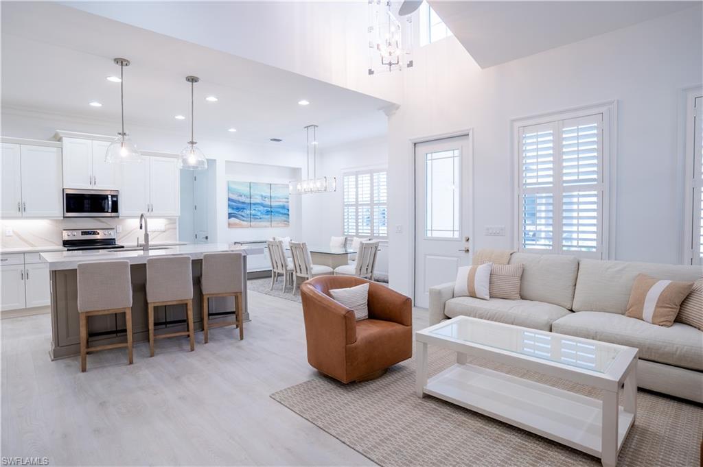 7150 Saona Court Naples, FL 34113 - Photo 3 of 31 a living room with furniture and a flat screen tv