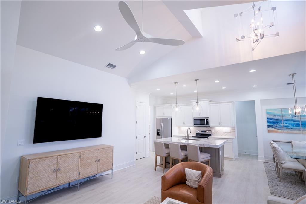 7150 Saona Court Naples, FL 34113 - Photo 4 of 31 a living room with furniture and a flat screen tv