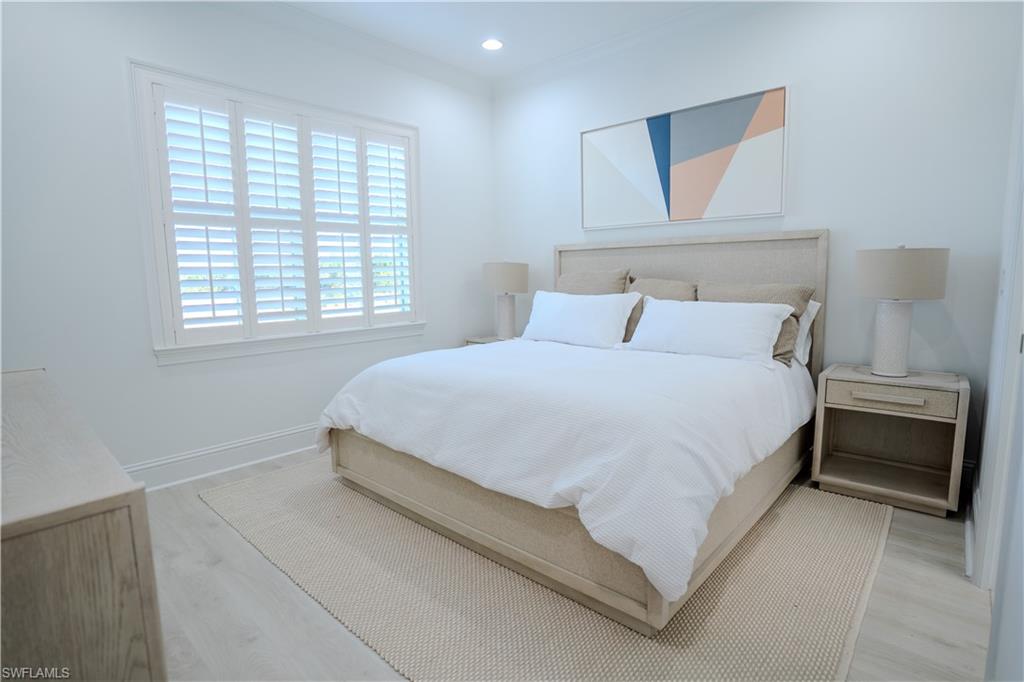 7150 Saona Court Naples, FL 34113 - Photo 5 of 31 a large bed sitting in a bedroom next to a window