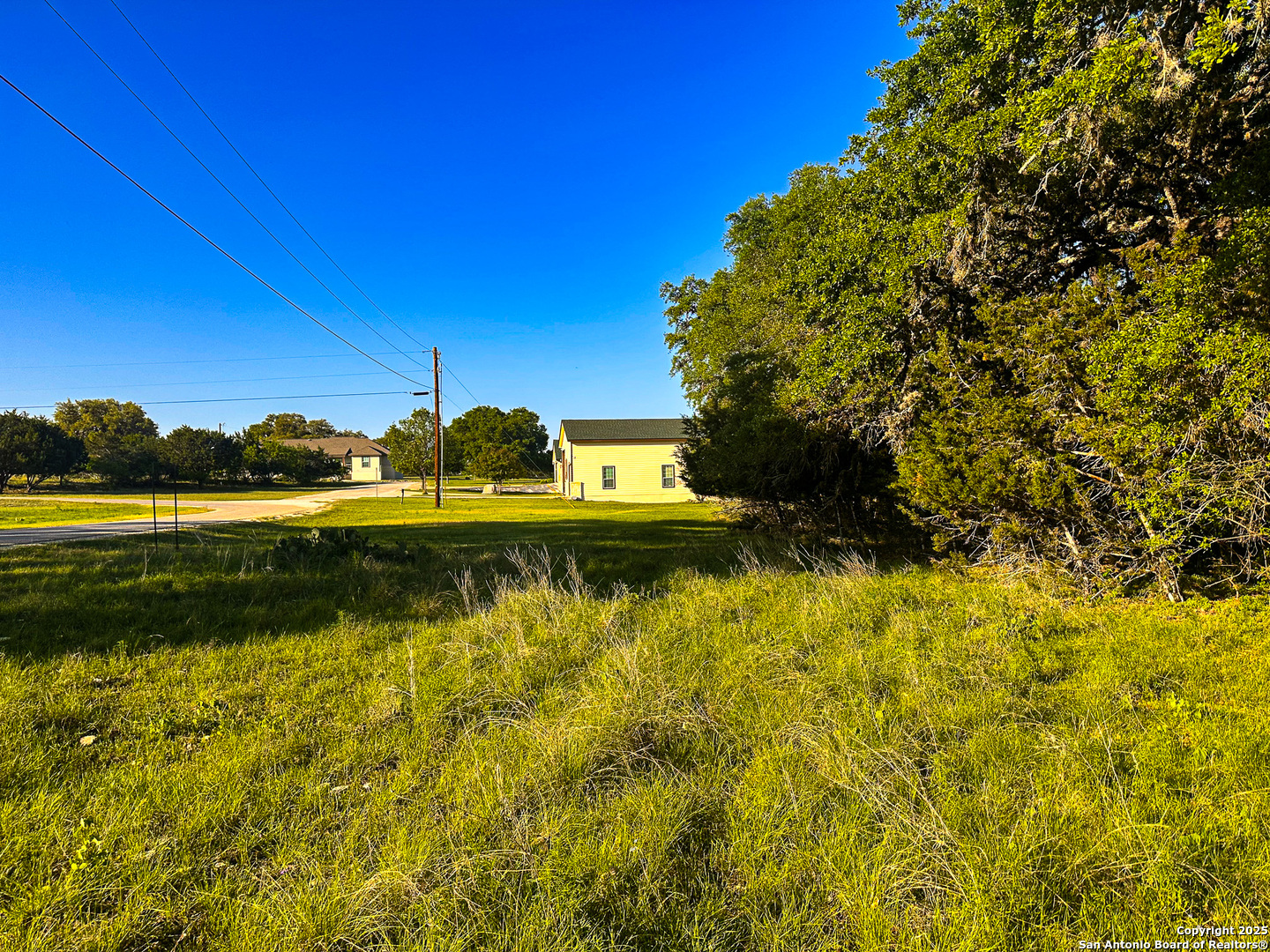Lot 12 Brown Saddle Bandera, TX 78003 - Photo 2 of 18 a view of a lake with a house in the background