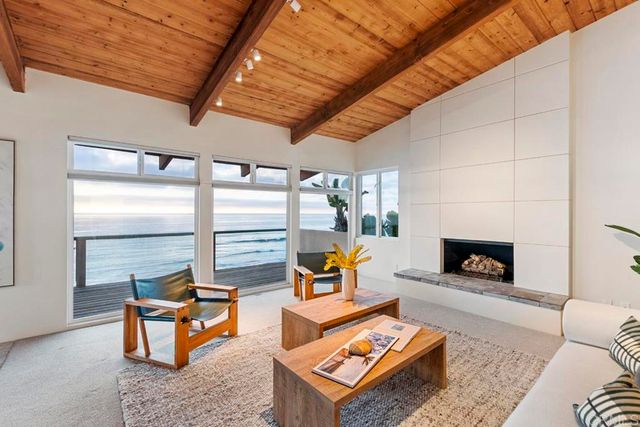 a living room with furniture a fireplace and next to a window