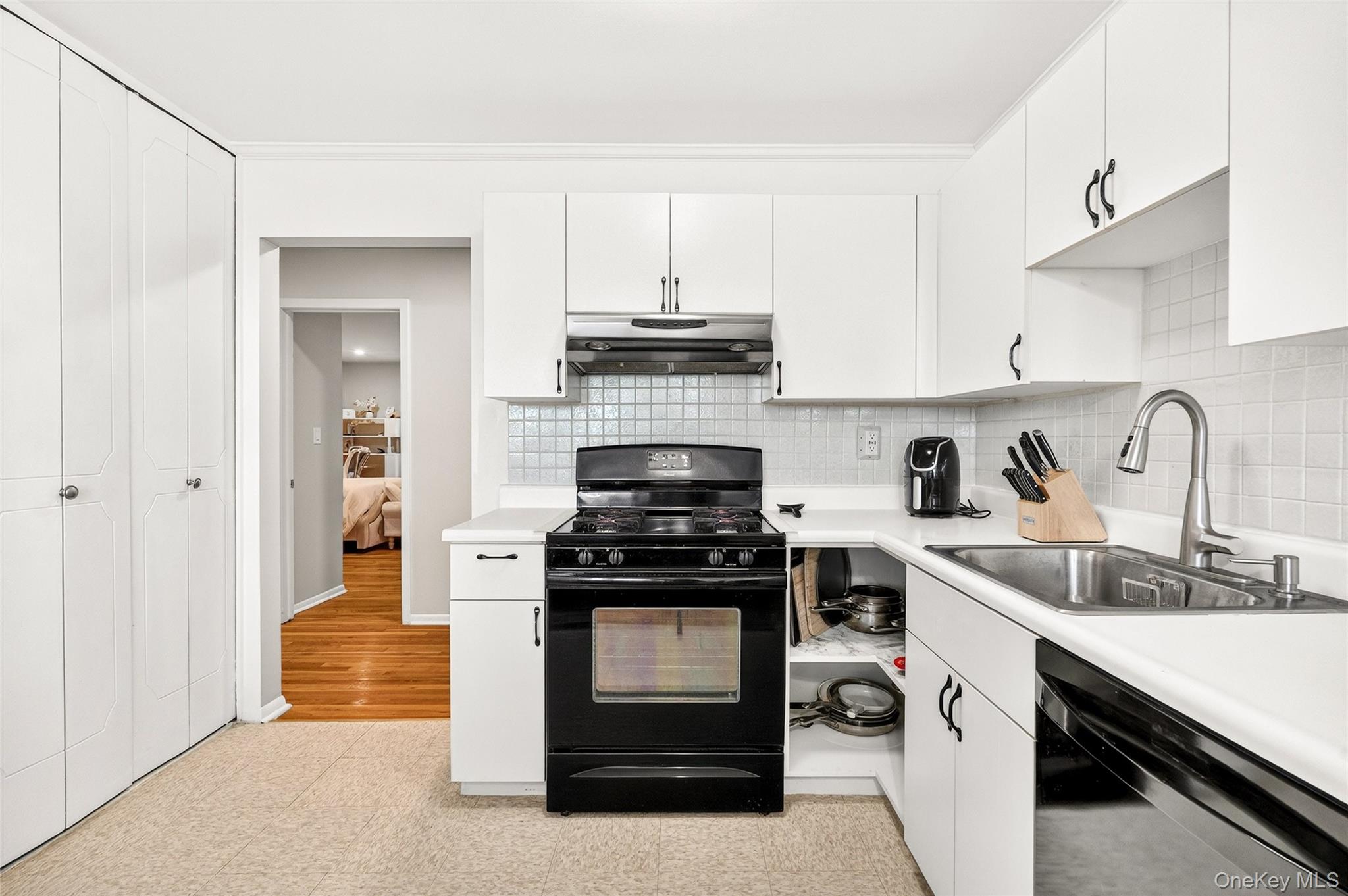100 Dowd Street, Unit D11 Haverstraw, NY 10927 - Photo 12 of 27 a kitchen with white cabinets and appliances