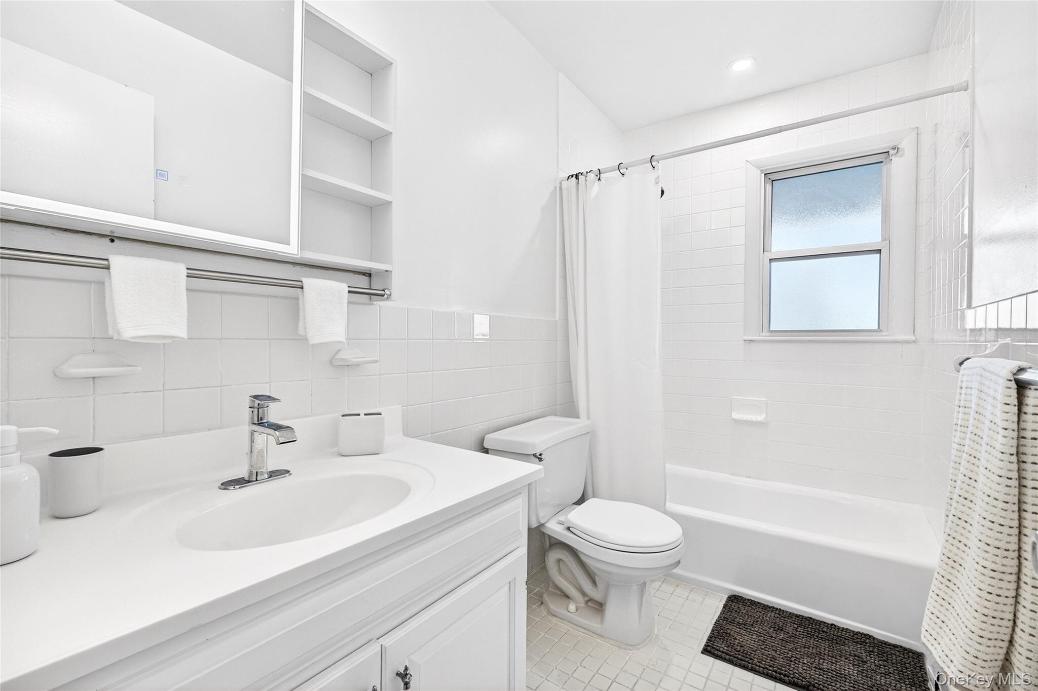 100 Dowd Street, Unit D11 Haverstraw, NY 10927 - Photo 26 of 27 a bathroom with a sink toilet a mirror and shower