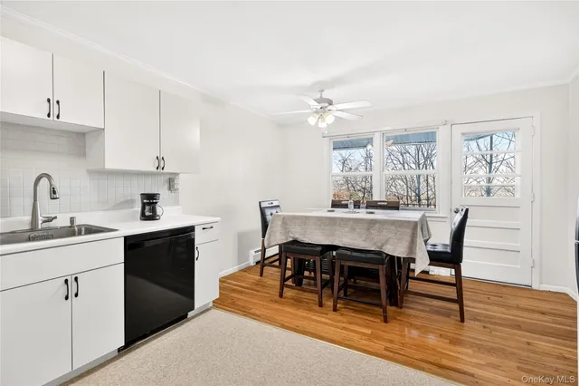 a dining room with a table chairs and kitchen view