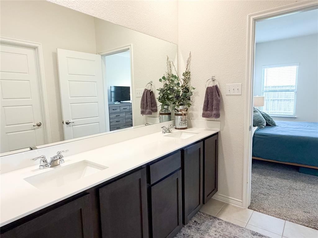 929 Philadelphia Street Fate, TX 75189 - Photo 18 of 34 a bathroom with a sink double vanity and a mirror