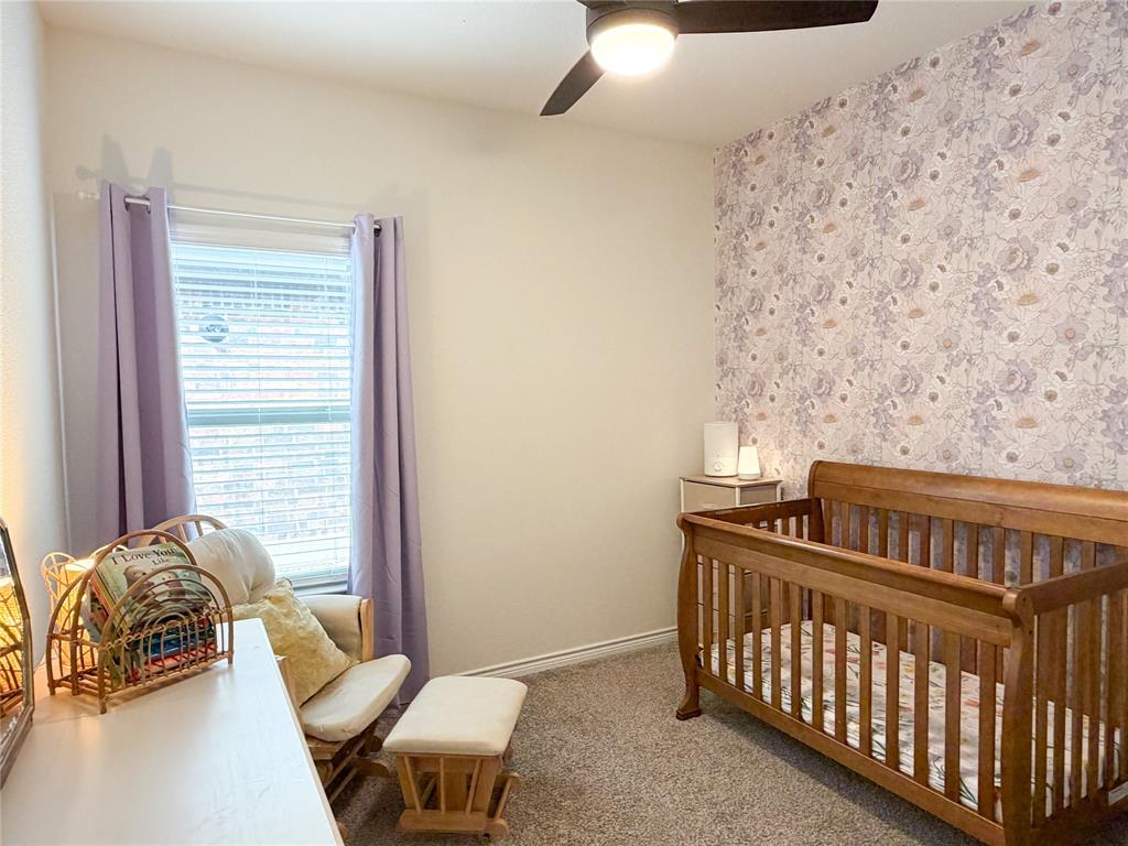 929 Philadelphia Street Fate, TX 75189 - Photo 22 of 34 a bedroom with furniture and a window
