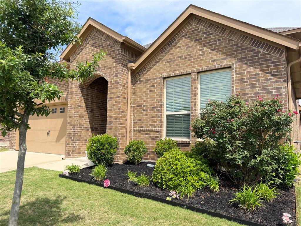 929 Philadelphia Street Fate, TX 75189 - Photo 26 of 34 a front view of a house with garden