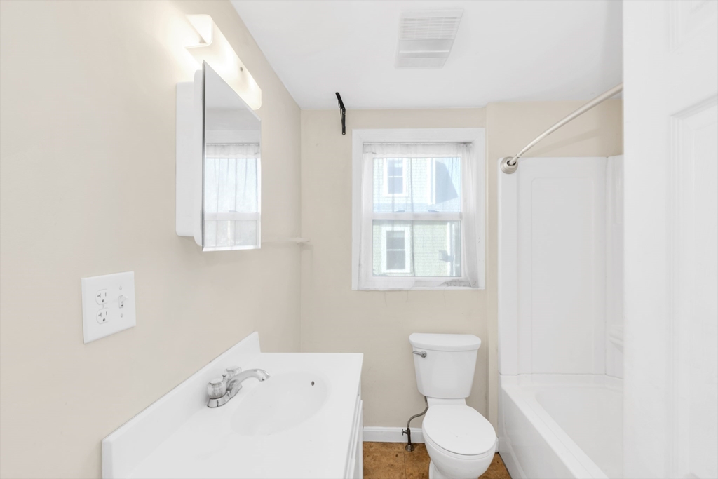 53 Brookside Avenue Boston, MA 02130 - Photo 13 of 28 a white toilet sitting next to a bathroom sink