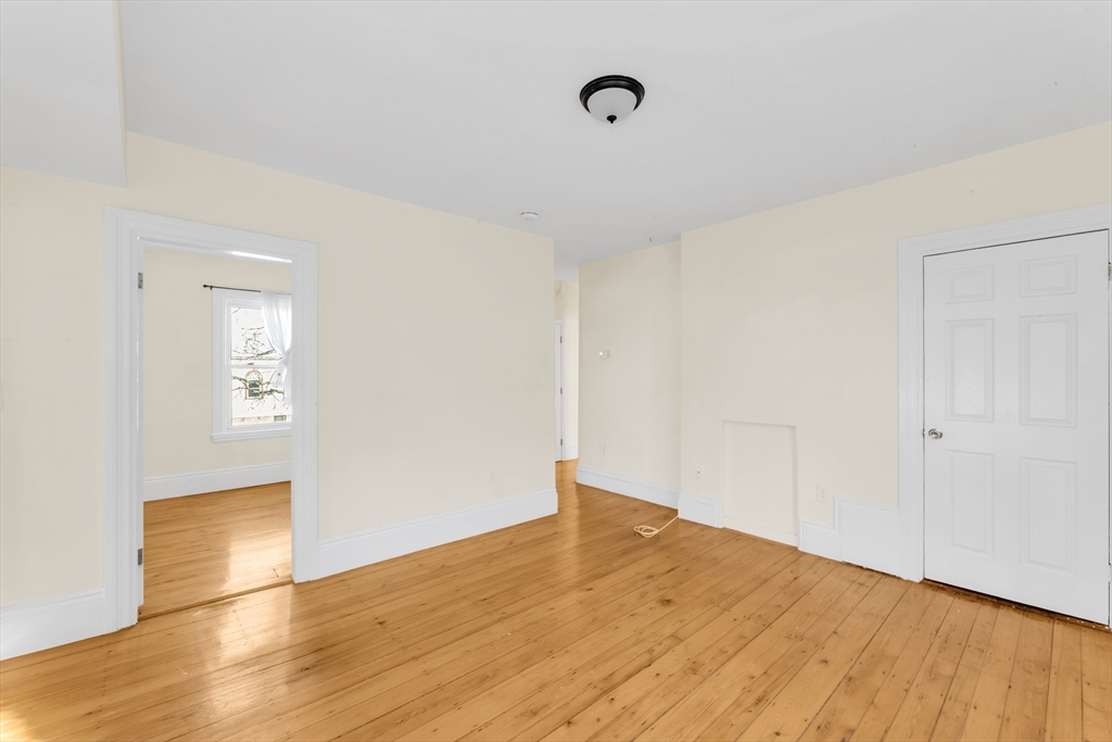 53 Brookside Avenue Boston, MA 02130 - Photo 14 of 28 a view of empty room with wooden floor and fan