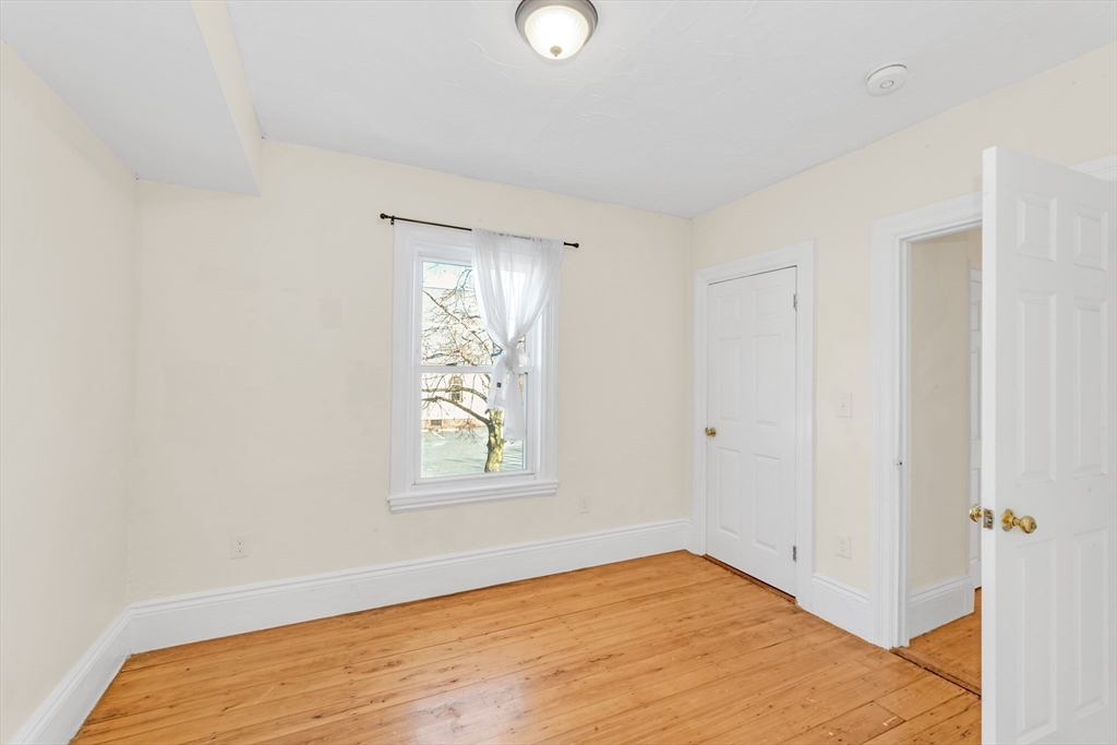 53 Brookside Avenue Boston, MA 02130 - Photo 15 of 28 a view of empty room with window and wooden floor