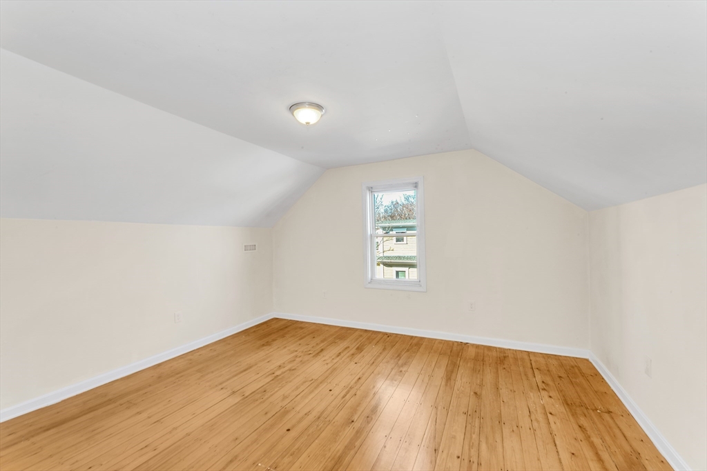 53 Brookside Avenue Boston, MA 02130 - Photo 19 of 28 an empty room with wooden floor and windows