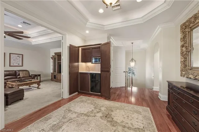 a view of a hallway with wooden floor and furniture
