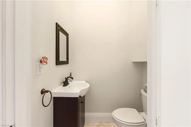 a bathroom with a shower sink vanity mirror and toilet