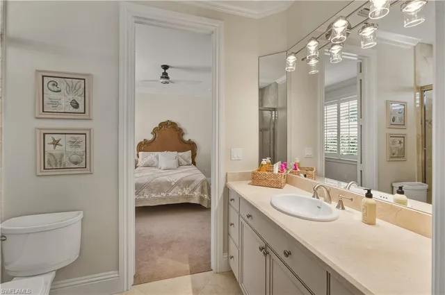 a en suite bathroom with a toilet sink and mirror