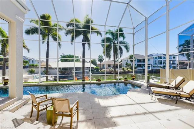 a view of swimming pool with outdoor seating