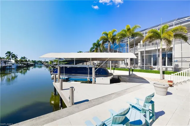a view of house with a swimming pool and sitting area