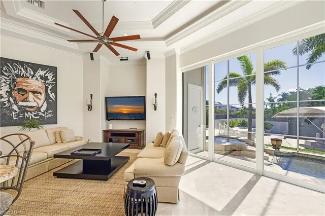 a living room with furniture fireplace and a large window