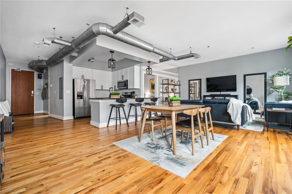 1029 Piedmont Avenue Northeast, Unit 303 Atlanta, GA 30309 - Photo 1 of 44 a view of a dining hall with lots of furniture and a flat screen tv