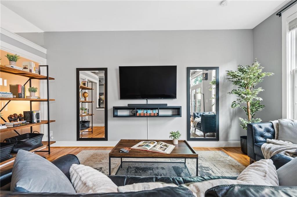 1029 Piedmont Avenue Northeast, Unit 303 Atlanta, GA 30309 - Photo 12 of 44 a living room with furniture and a flat screen tv