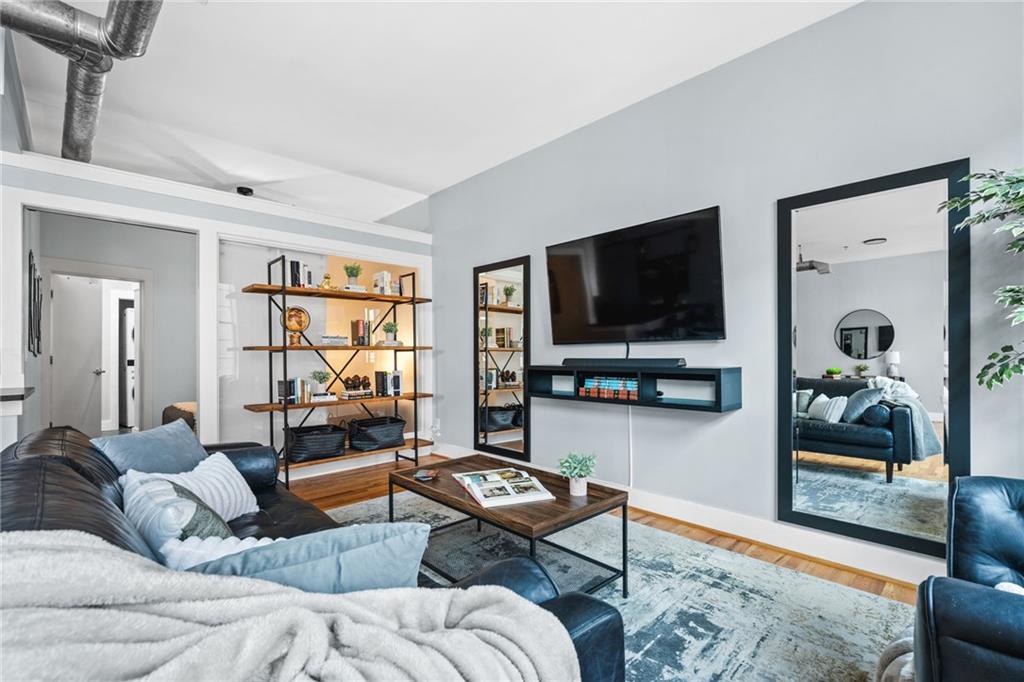 1029 Piedmont Avenue Northeast, Unit 303 Atlanta, GA 30309 - Photo 13 of 44 a living room with furniture and a flat screen tv