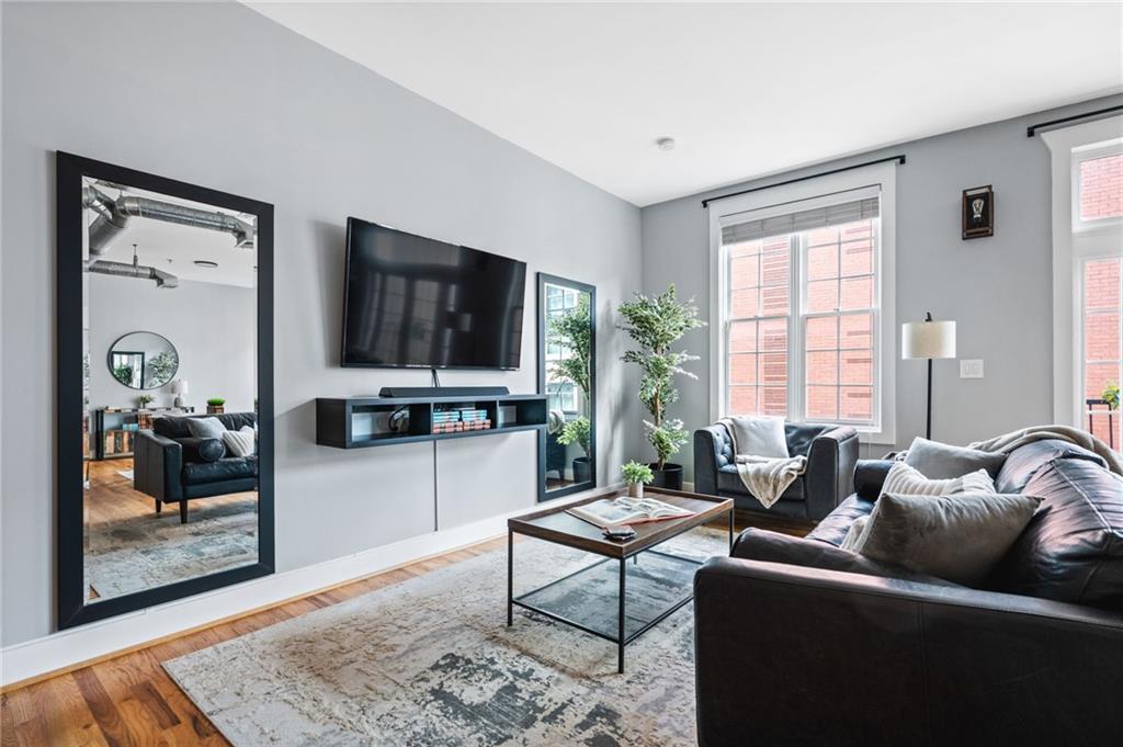 1029 Piedmont Avenue Northeast, Unit 303 Atlanta, GA 30309 - Photo 14 of 44 a living room with furniture and a flat screen tv