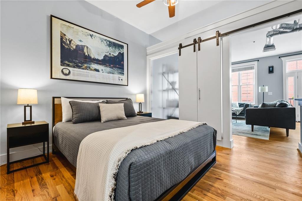 1029 Piedmont Avenue Northeast, Unit 303 Atlanta, GA 30309 - Photo 18 of 44 a bedroom with bed and wooden floor