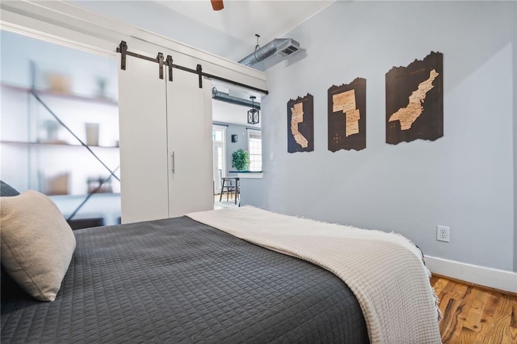 1029 Piedmont Avenue Northeast, Unit 303 Atlanta, GA 30309 - Photo 19 of 44 a bedroom with a large bed and a chandelier