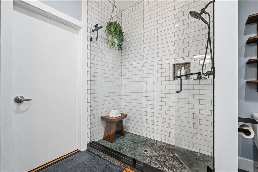 1029 Piedmont Avenue Northeast, Unit 303 Atlanta, GA 30309 - Photo 22 of 44 a bathroom with a toilet and a shower