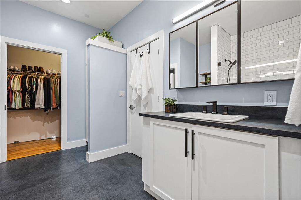 1029 Piedmont Avenue Northeast, Unit 303 Atlanta, GA 30309 - Photo 23 of 44 a bathroom with a sink and a mirror