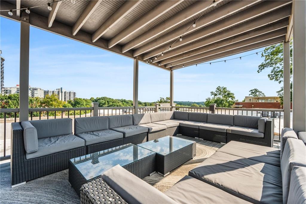 1029 Piedmont Avenue Northeast, Unit 303 Atlanta, GA 30309 - Photo 29 of 44 a roof deck with couches and potted plants