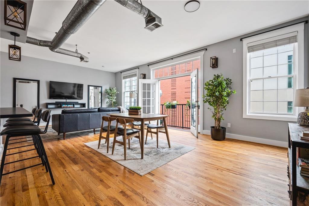 1029 Piedmont Avenue Northeast, Unit 303 Atlanta, GA 30309 - Photo 3 of 44 a view of a dining room with furniture window and wooden floor