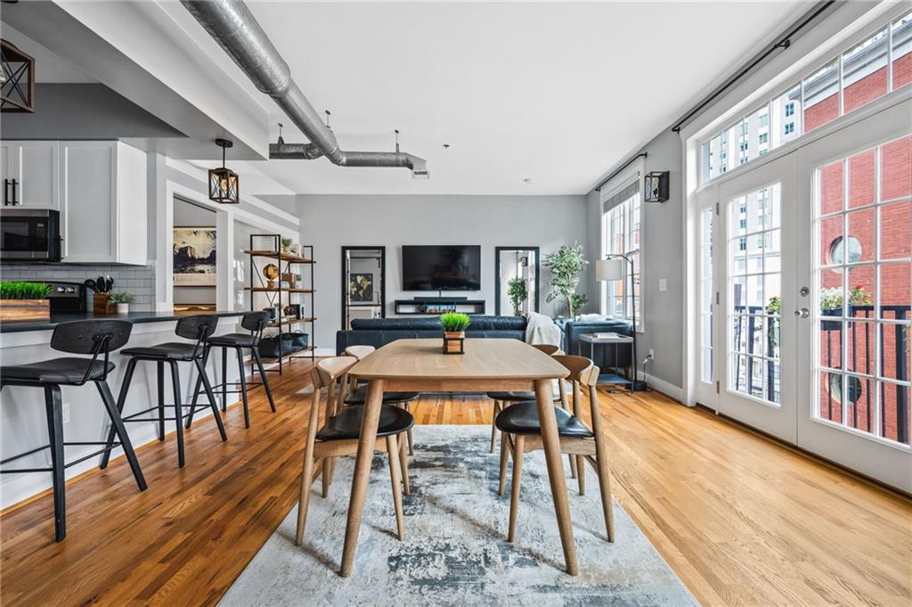 1029 Piedmont Avenue Northeast, Unit 303 Atlanta, GA 30309 - Photo 5 of 44 a dining room with furniture a rug and wooden floor