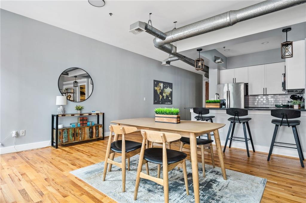 1029 Piedmont Avenue Northeast, Unit 303 Atlanta, GA 30309 - Photo 6 of 44 a view of a dining room with furniture and wooden floor